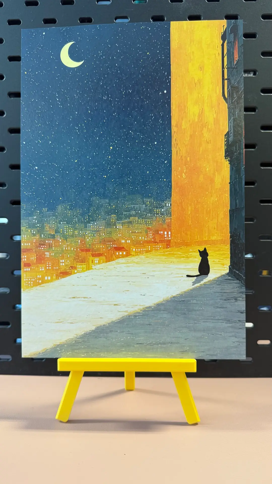 Moonlit City Cat fine art print showing a black cat overlooking a glowing city beneath a crescent moon and star-filled night sky